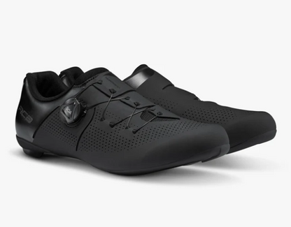 A pair of shimano rc3 black cycling shoes with perforated uppers and a dial closure system, shown on a light gray background.
