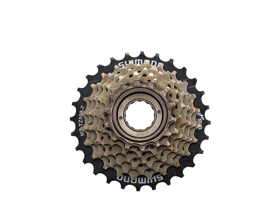 A Shimano bicycle cassette with a black outer ring and beige inner sprockets, shown against a plain white background.